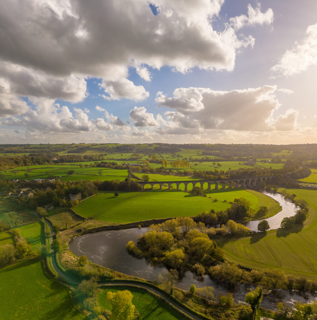 An aerial view over Arthington Viaduct and the River Wharfe on a sunny autumn day